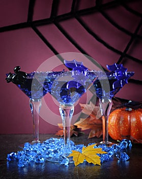 Happy Halloween ghoulish party cocktail drinks with blue martini glasses