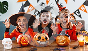 Happy Halloween! a group of children in suits and with pumpkins