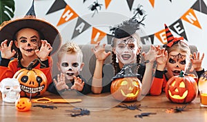 Happy Halloween! a group of children in suits and with pumpkins