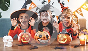 Happy Halloween! a group of children in suits and with pumpkins