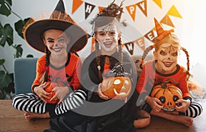 Happy Halloween! a group of children in suits and with pumpkins