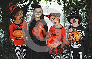 Happy Halloween! a group of children in suits and with pumpkins