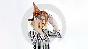 Happy Halloween holiday. Sexy woman in witch hat ready for Haloween party. Female wizard fairy character for All Saints