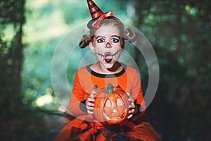 Happy Halloween! horrible creepy child girl in pumpkin costume