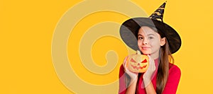 happy halloween. kid with pumpkin. trick or treat. teen girl on yellow background. Halloween kid girl portrait