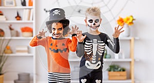 Happy Halloween. Kids in carnival costumes and makeup at home