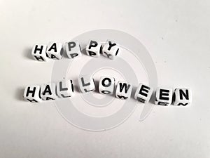 Happy Halloween lettering on white blocks on a white background