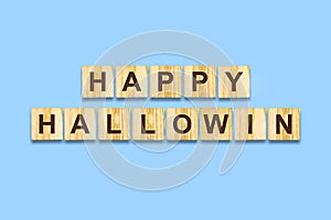 Happy Halloween lettering on wooden blocks on a blue background.Isolated Festive background. Holidays.