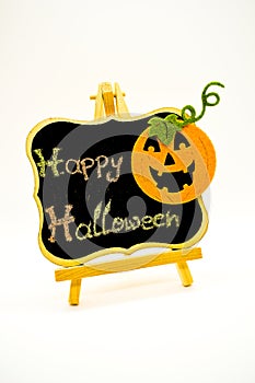 Happy Halloween message write on a blackboard with pumpkin. Isolated on white background.