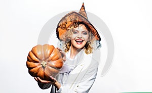 Happy Halloween party. Beautiful sexy woman in witch hat with Halloween pumpkin. Smiling Halloween witch with Pumpkin