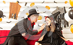 Happy Halloween party concept. Young man and woman wearing as vampires, witch or ghost celebrate the halloween festival