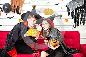 Happy Halloween party concept. Young man and woman wearing as vampires, witch or ghost celebrate the halloween festival