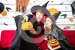 Happy Halloween party concept. Young man and woman wearing as vampires, witch or ghost celebrate the halloween festival