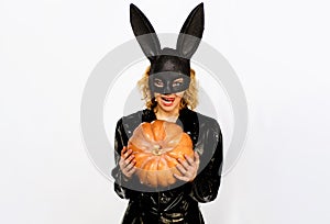 Happy Halloween. Sexy woman in Halloween costume with Pumpkin. Halloween party. Trick or treat. Blond girl in black