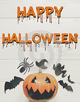 Happy halloween text flat lay. jack lantern pumpkin with witch g