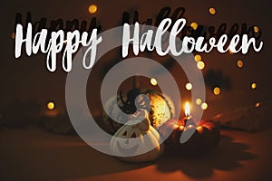 Happy Halloween text sign on pumpkin, jack o lantern, candle, spider on dark orange background with lights and flying black bats.