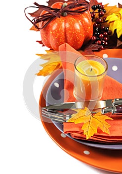 Happy Halloween or Thanksgiving party table place setting with orange and purple theme - vertical.