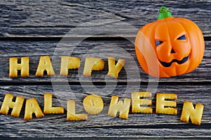 Happy Halloween words decoration with jack lantern pumpkin on wooden background
