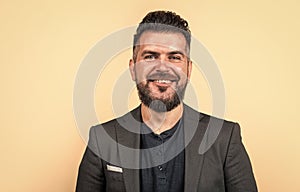 happy handsome businessman man with beard and bristle on unshaven face wearing stylish formal casual business jacket