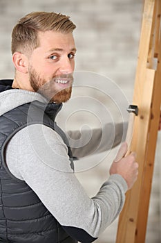 happy handsome cabinetmaker with tools