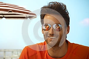 Happy handsome casual man wearing mirror shades