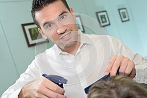 Happy handsome male hairdresser