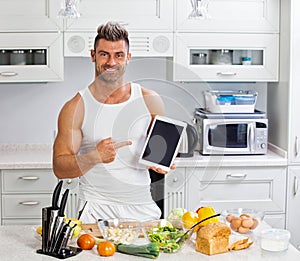 Happy handsome man cooking in kitchen at home.