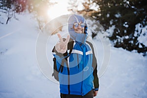 happy handsome man in snowy mountain at sunset. Travel and sport outdoors concept. Winter season