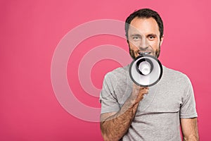 happy handsome man speaking with megaphone, isolated