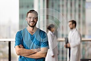 Happy handsome surgeon man looking at camera with toothy smile