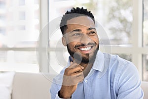 Happy handsome young African American business man looking away