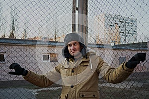 Happy handsome young man in cap with earflaps. The young man in the fur hat