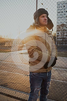 Happy handsome young man in cap with earflaps. The young man in the fur hat