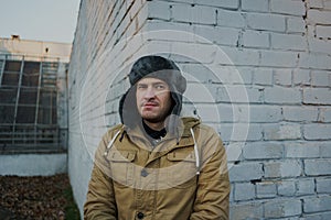 Happy handsome young man in cap with earflaps. The young man in the fur hat