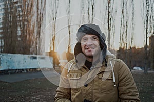 Happy handsome young man in cap with earflaps. The young man in the fur hat