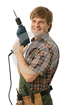 Happy handyman posing with power drill