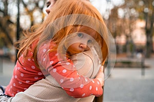 Happy harmonious family concept. Young mother and child daughter with red hair, together, hugging and joyfully laughing