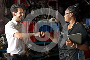 Happy harmony people work together at workplace, African American woman fist bumping hand after complete work with colleague at