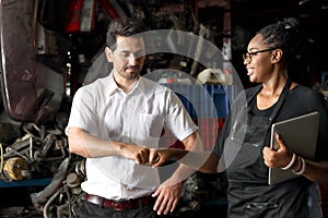 Happy harmony people work together at workplace, African American woman fist bumping hand after complete work with colleague at