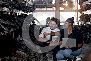 Happy harmony people at workplace, smiling white guy and African American woman working together Two workers check stock at auto