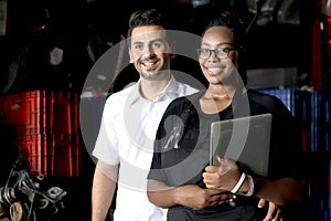 Happy harmony people at workplace, smiling white guy and African American woman working together Two workers check stock at auto