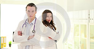 Happy health team and portrait of two young doctors standing in clinic