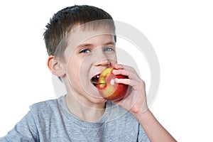 Happy healthy boy eating apple isolated