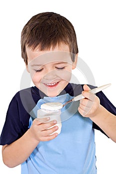 Happy healthy boy eating yogurt