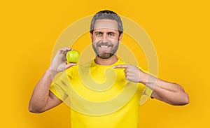 happy healthy man with vitamin fruit on background. healthy man with vitamin fruit in studio