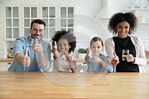 Happy healthy mixed race family recommending drinking water. photo