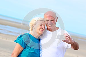 Happy healthy retired elders couple enjoying vacation on the beach