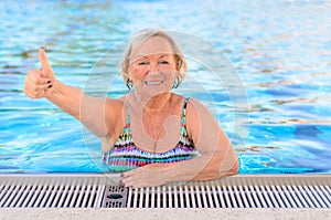 Happy healthy senior woman giving a thumbs up