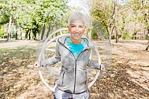 Happy Healthy Senior Woman Workout At Outdoor Gym In Nature