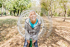 Happy Healthy Senior Woman Workout At Outdoor Gym In Nature